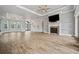 Open living space with fireplace, arched windows, and wood floors, perfect for entertaining at 602 Swilley Rd, Plant City, FL 33567