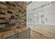 Living space featuring a glass wall, stone accents, and built-in bar area at 602 Swilley Rd, Plant City, FL 33567