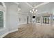 Expansive living room with light-colored wood-look flooring, recessed lighting, and a cozy fireplace, creating an inviting atmosphere at 602 Swilley Rd, Plant City, FL 33567