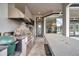 Covered outdoor kitchen featuring a grill, bar area, Big Green Egg and stainless appliances at 602 Swilley Rd, Plant City, FL 33567