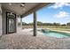 Covered patio area, pool with a waterfall feature and well-maintained landscaping at 602 Swilley Rd, Plant City, FL 33567