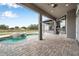 Covered patio showcasing the pool, spa and outdoor kitchen area at 602 Swilley Rd, Plant City, FL 33567