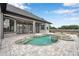 Back of house showing covered patio, pool, spa, and well-landscaped backyard at 602 Swilley Rd, Plant City, FL 33567