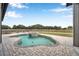 Backyard pool with paver patio, and views of the grassy fenced in yard at 602 Swilley Rd, Plant City, FL 33567