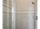 Walk-in shower featuring decorative gray tile and dual shower heads at 602 Swilley Rd, Plant City, FL 33567
