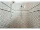Walk-in shower featuring decorative gray tile and dual shower heads at 602 Swilley Rd, Plant City, FL 33567
