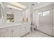 Bright bathroom with white cabinetry, large mirror, and tub and shower combo at 6101 Willow Oak Cir, Bradenton, FL 34209