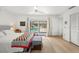 Comfortable bedroom with light wood floors and sliding door access to backyard at 6101 Willow Oak Cir, Bradenton, FL 34209