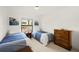 Cozy bedroom featuring two twin beds, a dresser, and bright natural light at 6101 Willow Oak Cir, Bradenton, FL 34209