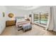 Comfortable bedroom with light wood floors and sliding door access to pool at 6101 Willow Oak Cir, Bradenton, FL 34209