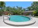A beautifully maintained community pool with a diving board surrounded by lush landscaping and seating at 6101 Willow Oak Cir, Bradenton, FL 34209