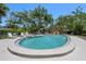 A wide open shot of the community pool with chairs and a ladder for easy entrance at 6101 Willow Oak Cir, Bradenton, FL 34209