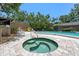 Community pool and hot tub area with tiled features and seating for residents to enjoy at 6101 Willow Oak Cir, Bradenton, FL 34209
