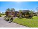 Charming single-story home with a brick exterior, attached garage, and a well-manicured front yard with a palm tree at 6101 Willow Oak Cir, Bradenton, FL 34209