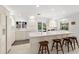 Bright kitchen with white cabinetry, long breakfast bar, and view to outdoor pool at 6101 Willow Oak Cir, Bradenton, FL 34209