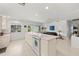 Bright kitchen with white cabinets, island cooktop, and open floor plan to living room at 6101 Willow Oak Cir, Bradenton, FL 34209