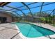 Inviting backyard pool with screened enclosure surrounded by a brick patio at 6101 Willow Oak Cir, Bradenton, FL 34209