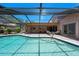 Sparkling pool with screened enclosure and an outdoor dining set at 6101 Willow Oak Cir, Bradenton, FL 34209