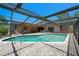 Backyard pool with screened enclosure and outdoor lounging space at 6101 Willow Oak Cir, Bradenton, FL 34209