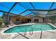 A luxurious screened-in pool area with a brick patio, lounge chairs, and a sparkling blue pool, ideal for outdoor enjoyment at 6101 Willow Oak Cir, Bradenton, FL 34209