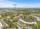 Expansive aerial view showcases the community's lush landscaping, ponds, and convenient access to beaches at 6188 80Th N St # 101, St Petersburg, FL 33709
