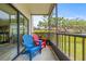 Balcony view with colorful Adirondack chairs and a serene view of the surrounding landscape at 6188 80Th N St # 101, St Petersburg, FL 33709