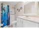 Bathroom featuring a shower, sink, and toilet with a mermaid themed curtain at 6188 80Th N St # 101, St Petersburg, FL 33709