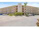 Attractive condo building exterior featuring multiple levels, balconies, and well-maintained landscaping at 6188 80Th N St # 101, St Petersburg, FL 33709