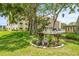 Manicured landscaping with patriotic accents complement the building's facade, enhancing curb appeal and creating a welcoming entrance at 6188 80Th N St # 101, St Petersburg, FL 33709
