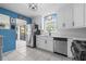 Bright kitchen featuring stainless steel appliances, ample countertop space, and trendy blue accent wall at 6188 80Th N St # 101, St Petersburg, FL 33709