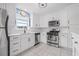 Bright, renovated kitchen featuring white cabinetry, stainless steel appliances, and sleek countertops at 6188 80Th N St # 101, St Petersburg, FL 33709