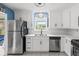 Bright eat-in kitchen features white cabinets, stainless steel appliances and tile flooring at 6188 80Th N St # 101, St Petersburg, FL 33709