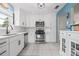 Well-lit kitchen with white cabinetry, modern stainless steel appliances, and neutral countertops at 6188 80Th N St # 101, St Petersburg, FL 33709