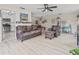 Spacious living room with hardwood floors, neutral paint, ceiling fan and comfortable seating at 6188 80Th N St # 101, St Petersburg, FL 33709