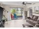 Open-concept living room leading to a screened balcony overlooking a tranquil pond at 6188 80Th N St # 101, St Petersburg, FL 33709