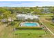 Community amenities featuring a refreshing pool, lounge area, and shuffleboard courts surrounded by trees at 6188 80Th N St # 101, St Petersburg, FL 33709