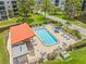 Aerial shot of the community pool with lounge chairs, tables, and shade for relaxing by the water at 6188 80Th N St # 101, St Petersburg, FL 33709