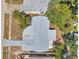 Aerial view shows a home with a well maintained roof, a driveway, and surrounding trees at 6309 7Th Ave, New Port Richey, FL 34653