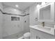 Updated bathroom features tiled walls, a new shower, and modern vanity with a countertop sink at 6309 7Th Ave, New Port Richey, FL 34653