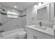Modern bathroom featuring a combination tub and shower with a new sink and vanity at 6309 7Th Ave, New Port Richey, FL 34653