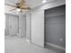Bright bedroom features a ceiling fan and sliding closet doors, providing ample storage space at 6309 7Th Ave, New Port Richey, FL 34653