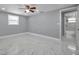 Spacious bedroom with a ceiling fan, marble floors and an ensuite bathroom at 6309 7Th Ave, New Port Richey, FL 34653