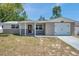 Charming single Gathering home featuring a decorative front door, garage, and inviting curb appeal at 6309 7Th Ave, New Port Richey, FL 34653