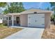 Charming single Gathering home featuring a decorative front door and a one car garage at 6309 7Th Ave, New Port Richey, FL 34653