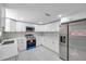 Modern kitchen featuring stainless steel appliances, marble floors, and white cabinetry at 6309 7Th Ave, New Port Richey, FL 34653