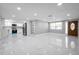 Open floor plan featuring a kitchen with stainless steel appliances and white cabinetry at 6309 7Th Ave, New Port Richey, FL 34653