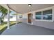 Covered front porch with decorative columns, front door, and well maintained landscaping at 6309 7Th Ave, New Port Richey, FL 34653