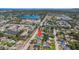 Aerial view highlighting a residential neighborhood with mature trees and proximity to a lake at 6490 22Nd S St, St Petersburg, FL 33712