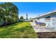 Expansive backyard featuring lush green grass, a patio, and privacy fence at 6490 22Nd S St, St Petersburg, FL 33712