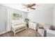 Bright bedroom with a crib, dresser with changing top, and cozy chair at 6490 22Nd S St, St Petersburg, FL 33712